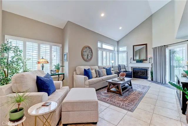 a living room with fireplace furniture and a large window
