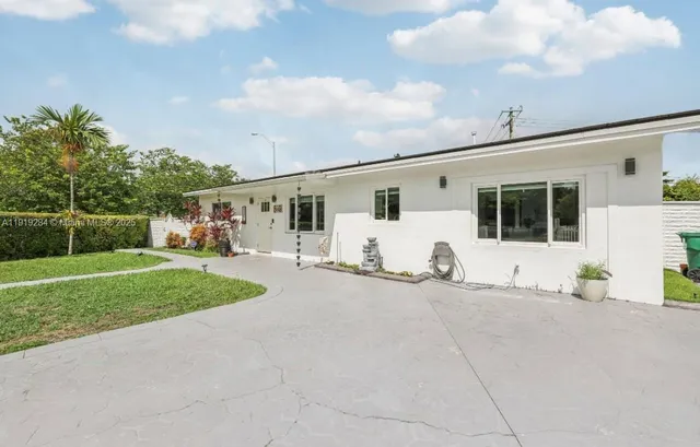 a view of a white house with a patio