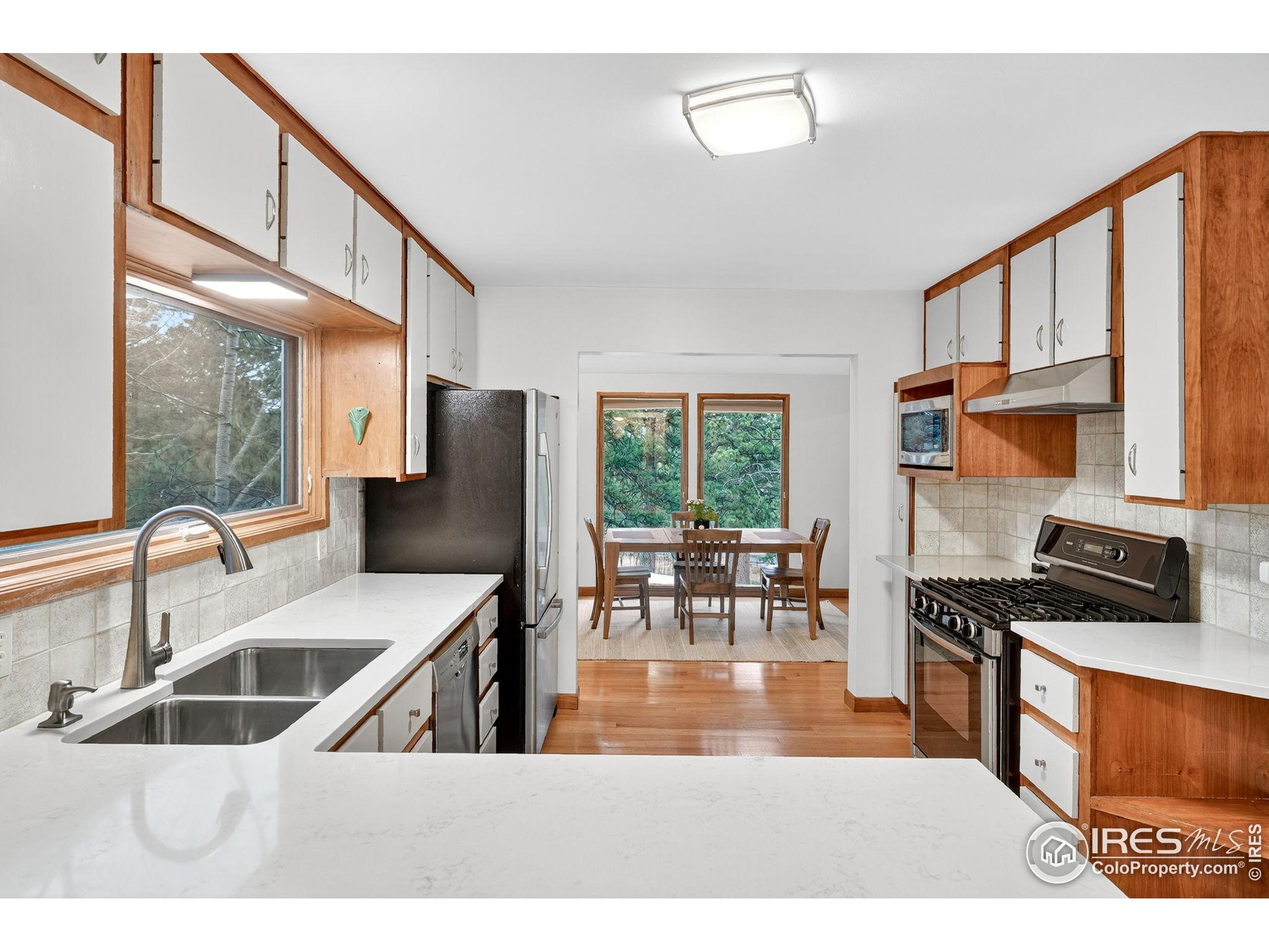 1707 Ridge Road Nederland, CO 80466 - Photo 22 of 50 a kitchen with stainless steel appliances granite countertop a sink a stove and a refrigerator