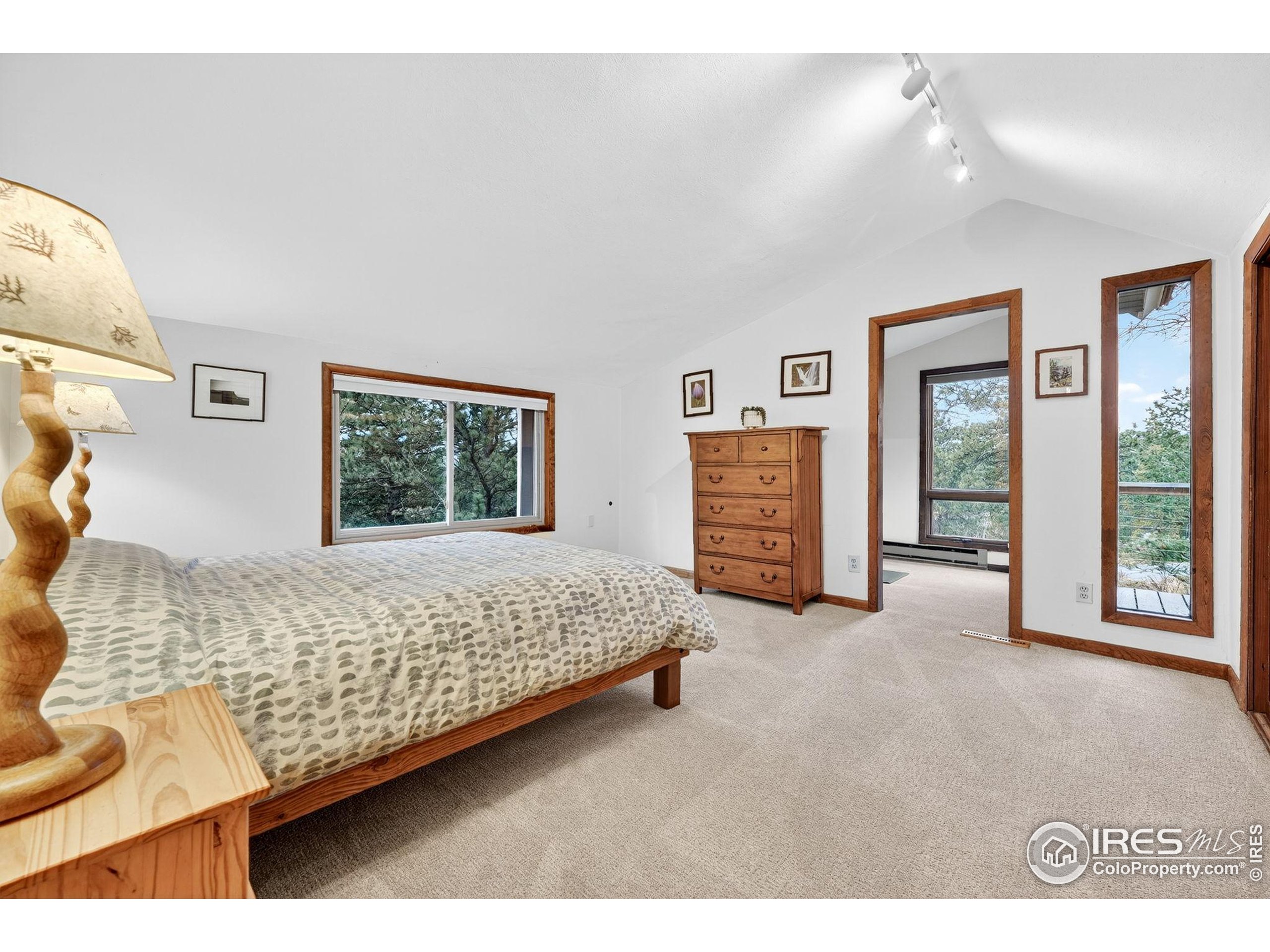 1707 Ridge Road Nederland, CO 80466 - Photo 27 of 50 a bedroom with a bed and a large mirror