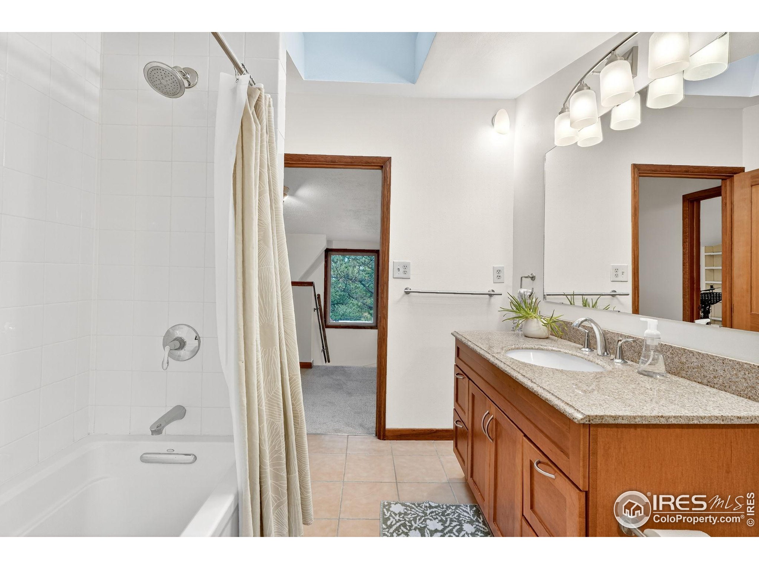 1707 Ridge Road Nederland, CO 80466 - Photo 33 of 50 a bathroom with a sink a mirror and a shower