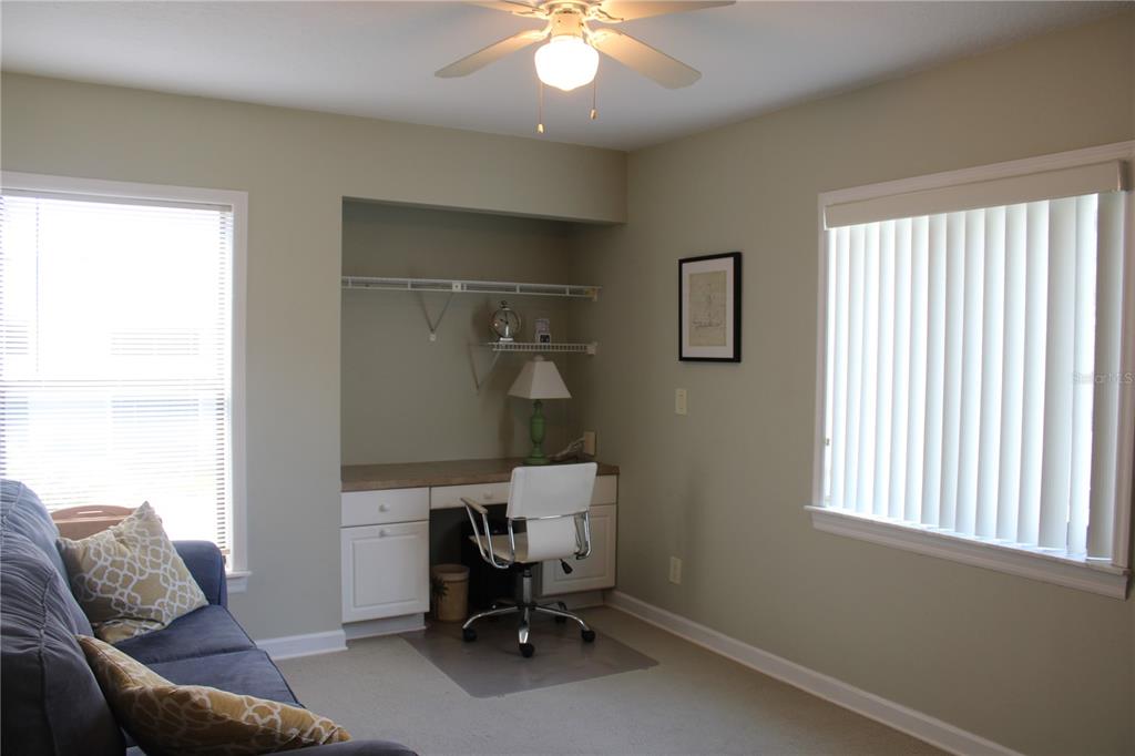 335 Windrush Loop, Unit 335 Tarpon Springs, FL 34689 - Photo 14 of 18 a living room with furniture and a window