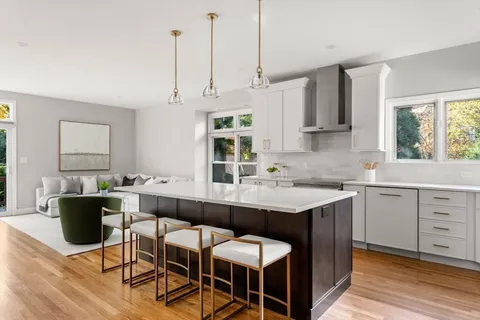 a kitchen with a sink cabinets and window