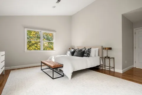a living room with a bed furniture and a window