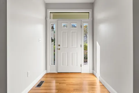 a view of a hallway with wooden floor