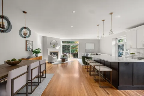 a very nice looking dining room with a large window and stainless steel appliances