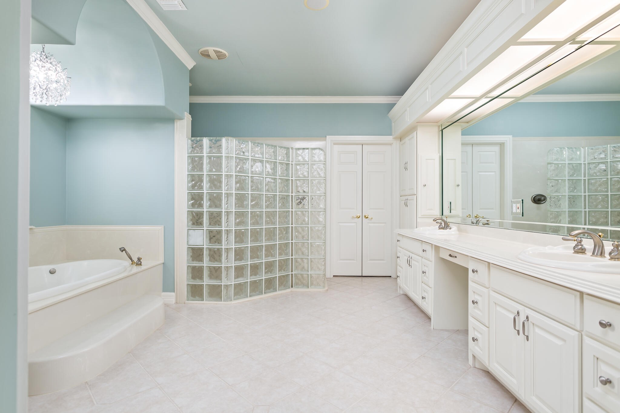 145 Greenhead Point Orange, TX 77630 - Photo 24 of 49 a spacious bathroom with a double vanity sink a mirror and a bathtub