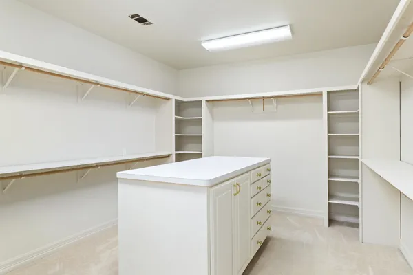 a utility room with cabinets washer and dryer