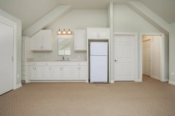 a view of a kitchen with white cabinets