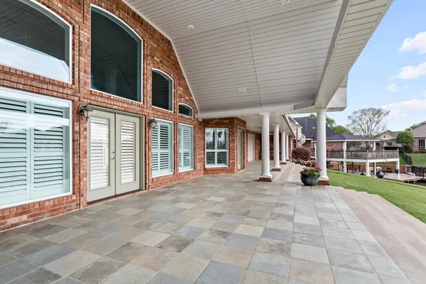 a view of a house with backyard porch and sitting area