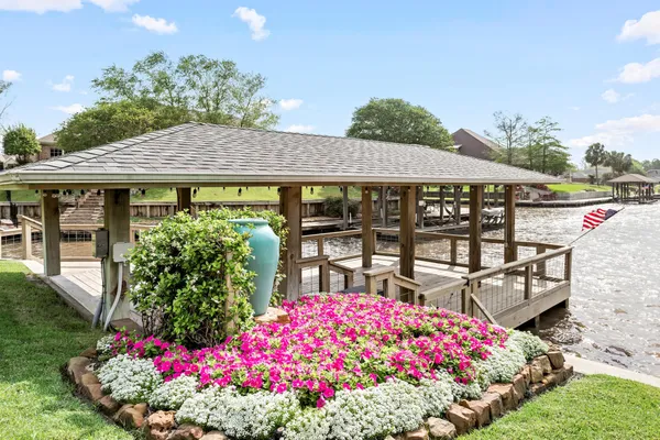 a front view of a house with a big yard and potted plants