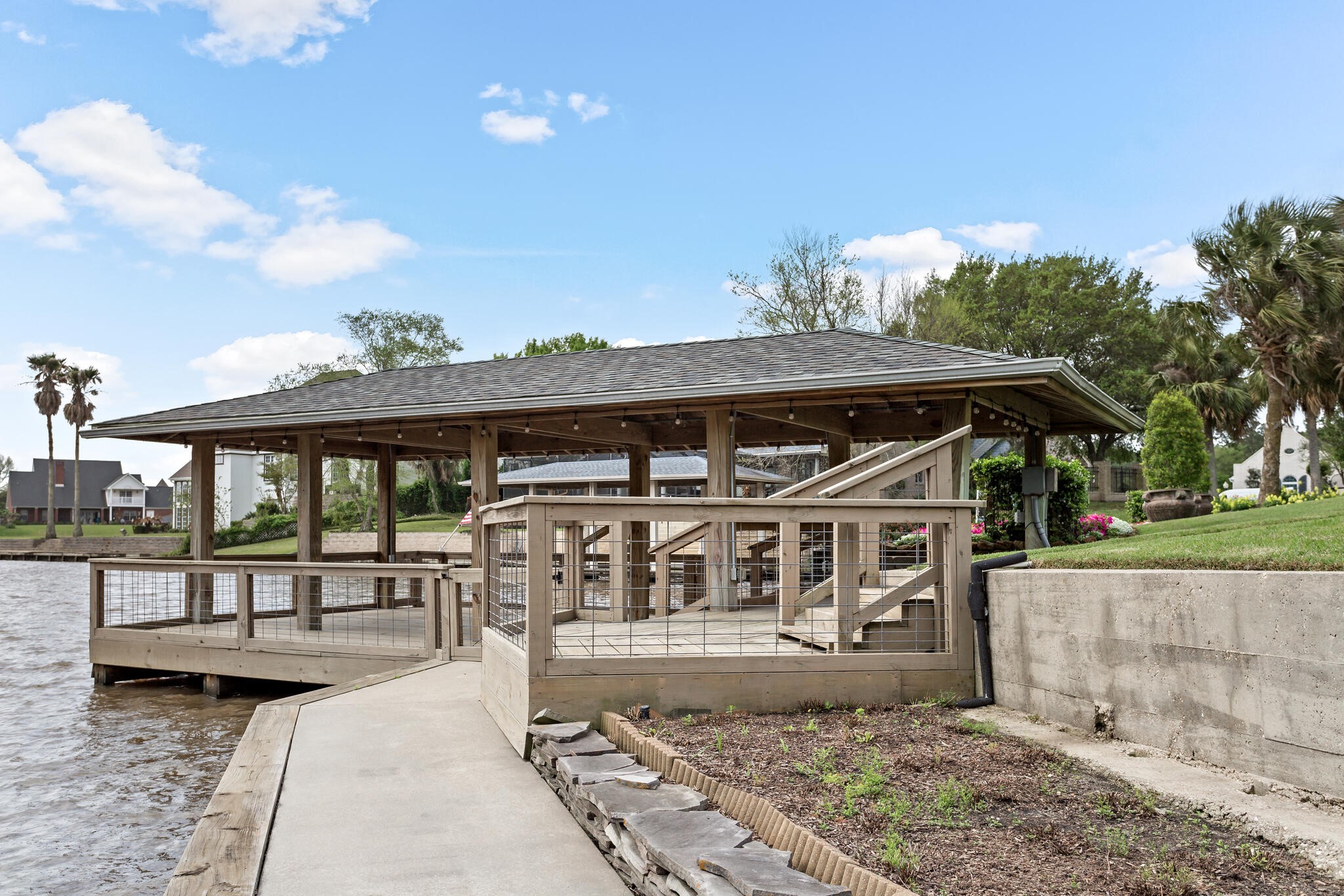 145 Greenhead Point Orange, TX 77630 - Photo 45 of 49 a view of a porch with a table and chairs under an umbrella
