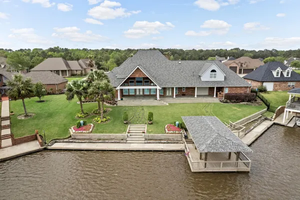 an aerial view of a house with swimming pool and garden
