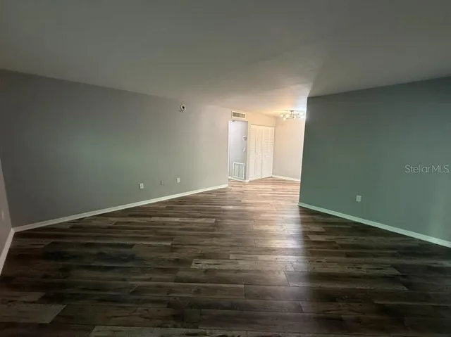 a view of a room with wooden floor