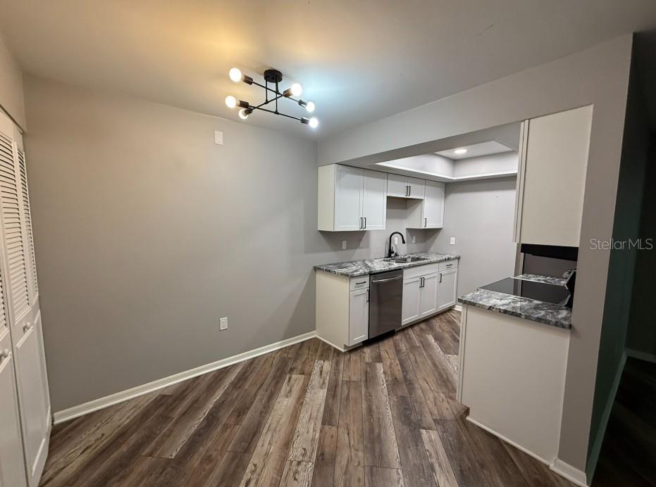 5800 Hollywood Boulevard, Unit 324 Sarasota, FL 34231 - Photo 4 of 11 a kitchen with a sink window and cabinets