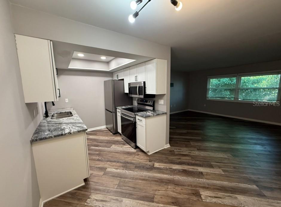 5800 Hollywood Boulevard, Unit 324 Sarasota, FL 34231 - Photo 5 of 11 a kitchen with granite countertop a stove and a sink