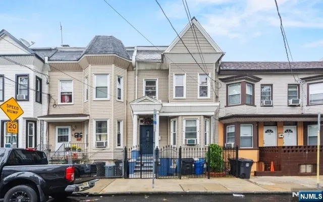 a front view of a residential apartment building with a yard