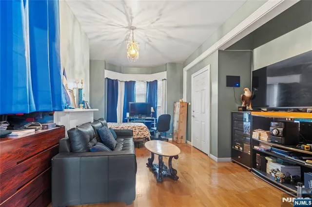 a living room with furniture and a chandelier