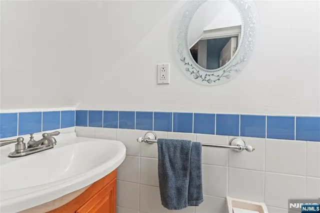 a kitchen with granite countertop a table chairs and a refrigerator