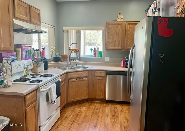 a kitchen with a sink stove and cabinets