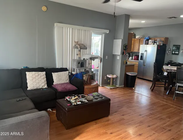 a living room with furniture and a wooden floor