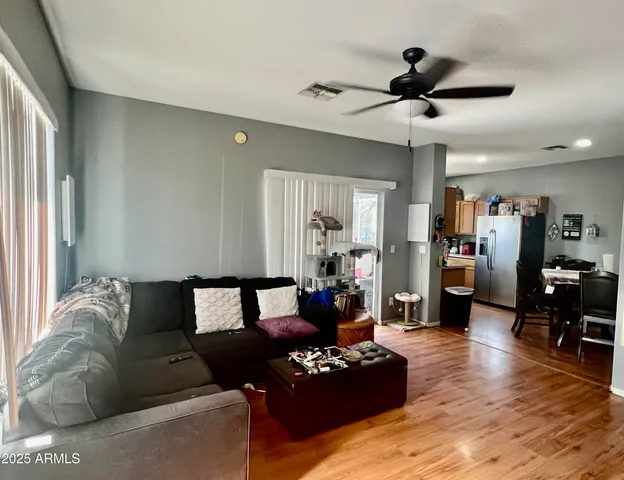 a living room with furniture and wooden floor