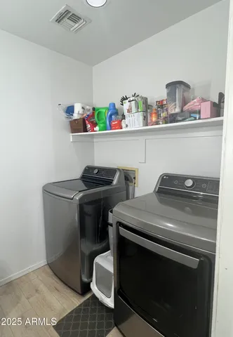 a utility room with sink dryer and washer