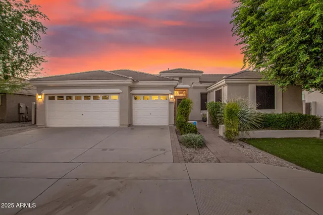a front view of house with yard and trees around