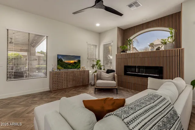 a living room with furniture a window and a fireplace