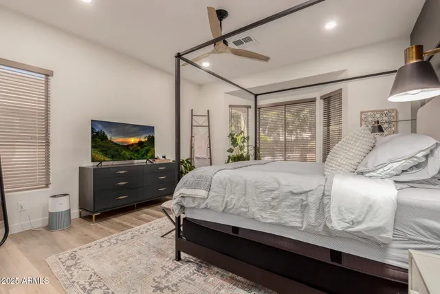 a bedroom with two beds and a chandelier