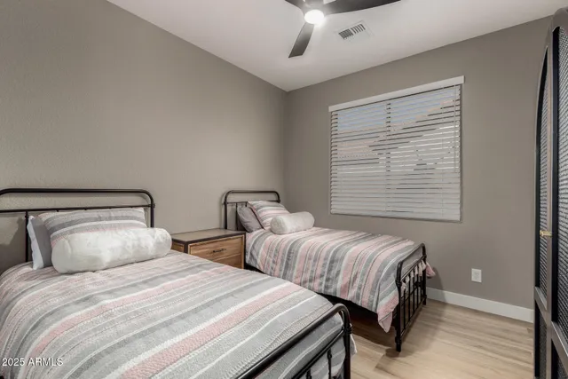 a bathroom with a double vanity sink mirror and toilet