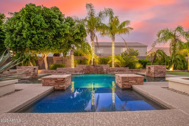 a view of a backyard with swimming pool