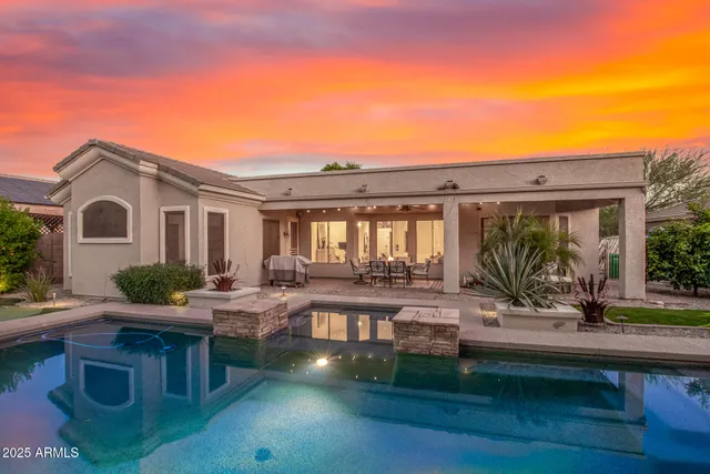 a swimming pool with outdoor seating and yard