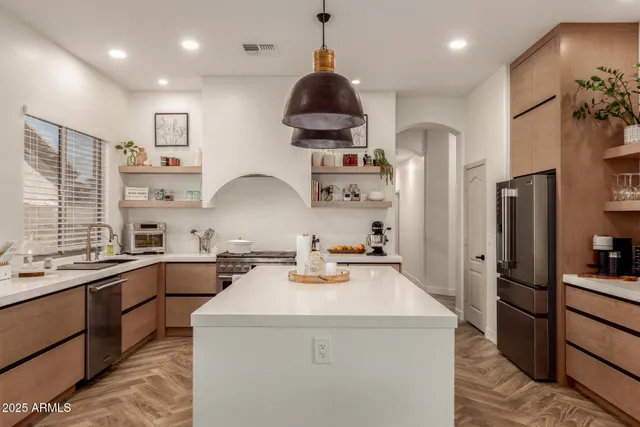 a kitchen that has a lot of counter space and a refrigerator
