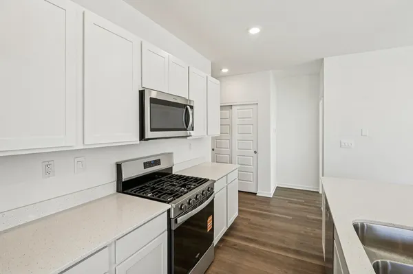 a kitchen with a stove and a microwave