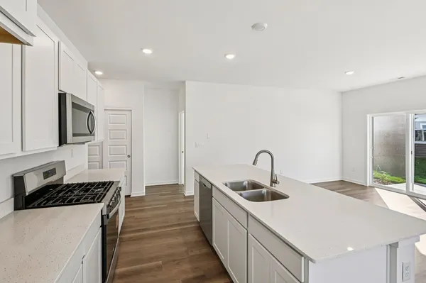 a kitchen with sink a stove and refrigerator