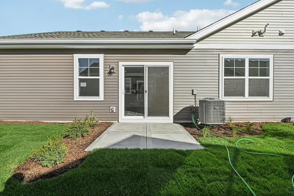 a view of a house with backyard and sitting area