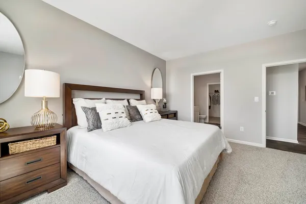 a bedroom with a bed and a lamp