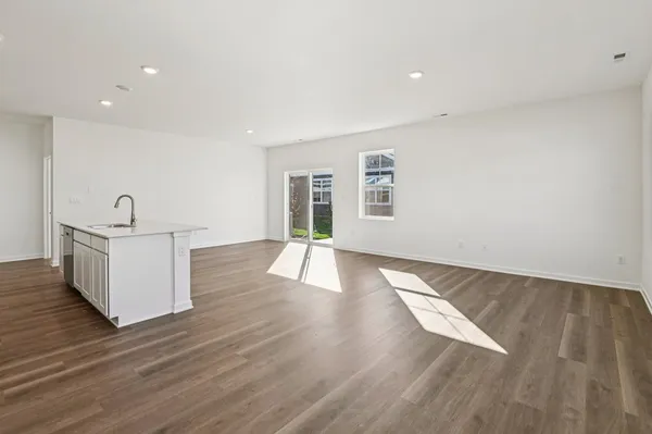 a view of a room with wooden floor and window