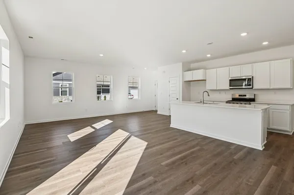 a view of kitchen with microwave and cabinets