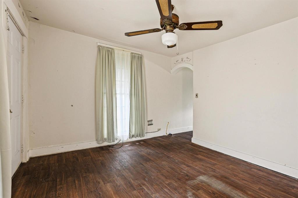 421 East Hull Street Denison, TX 75021 - Photo 11 of 33 an empty room with wooden floor fan and windows