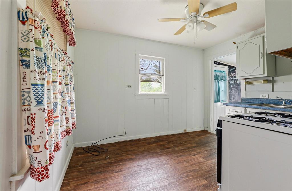 421 East Hull Street Denison, TX 75021 - Photo 15 of 33 a kitchen with a stove a refrigerator and a stove top oven