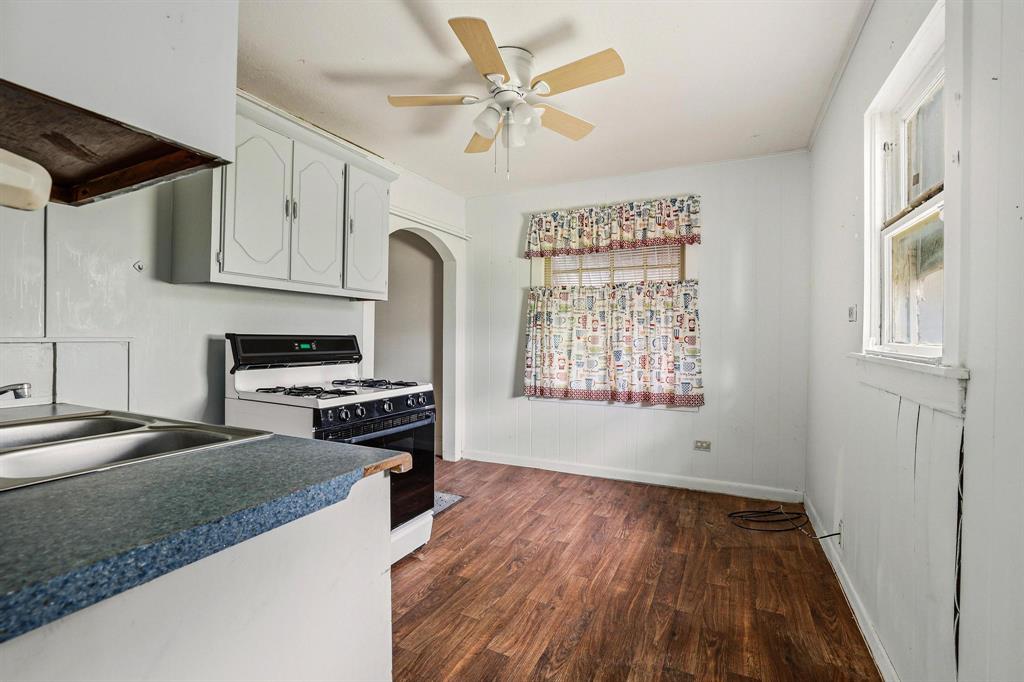 421 East Hull Street Denison, TX 75021 - Photo 17 of 33 a kitchen with stainless steel appliances granite countertop a stove a sink and a refrigerator