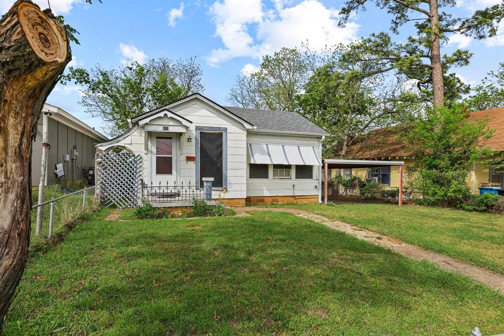 421 East Hull Street Denison, TX 75021 - Photo 3 of 33 a front view of a house with a garden and trees