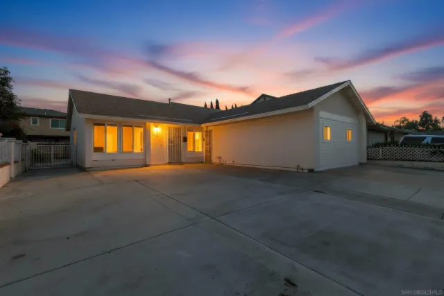 a view of backyard with a large tree