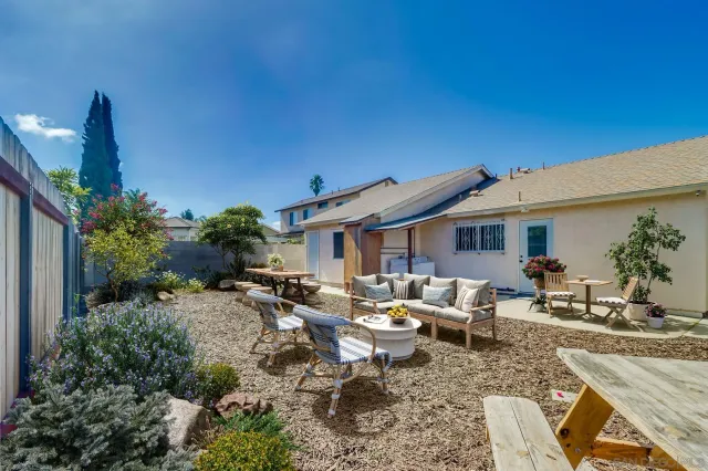 a backyard of a house with outdoor seating