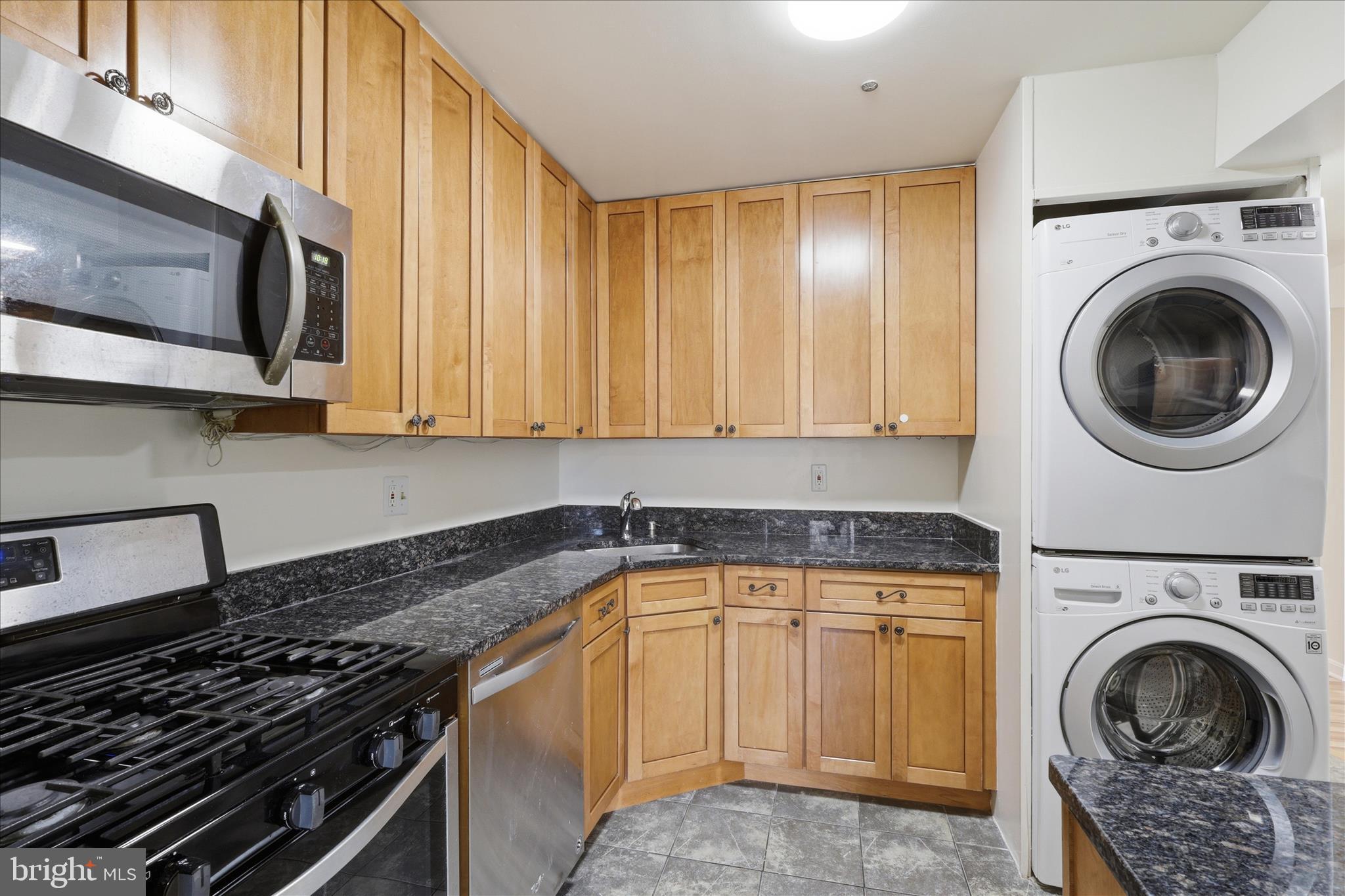 1433 Northgate Square, Unit 11B Reston, VA 20190 - Photo 13 of 44 a kitchen with a stove sink and cabinets