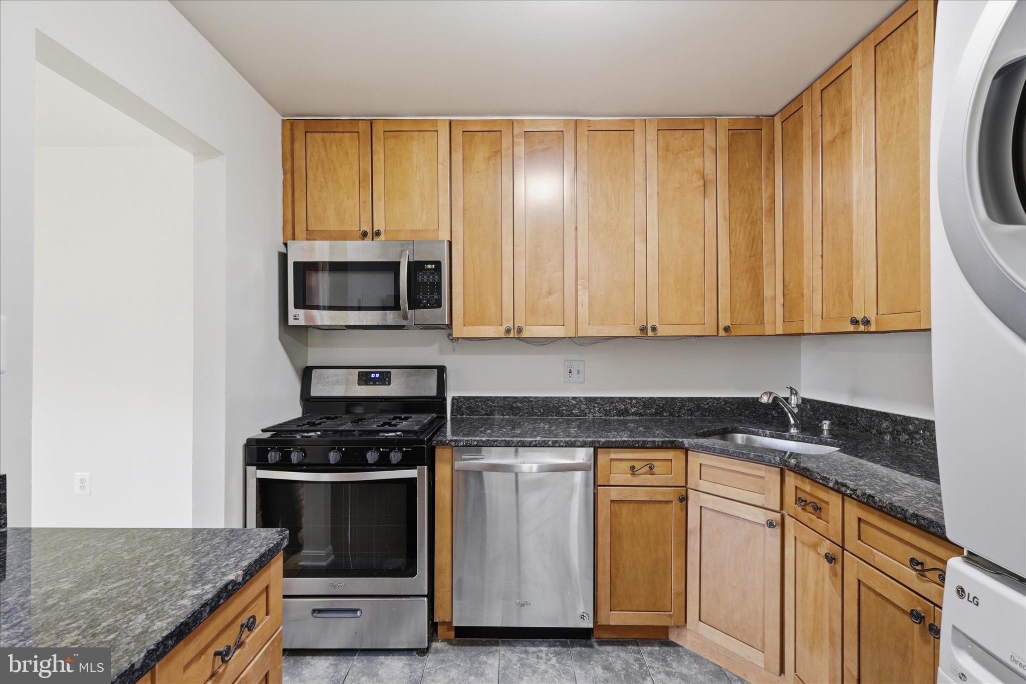 1433 Northgate Square, Unit 11B Reston, VA 20190 - Photo 14 of 44 a kitchen with granite countertop cabinets stainless steel appliances and a counter space