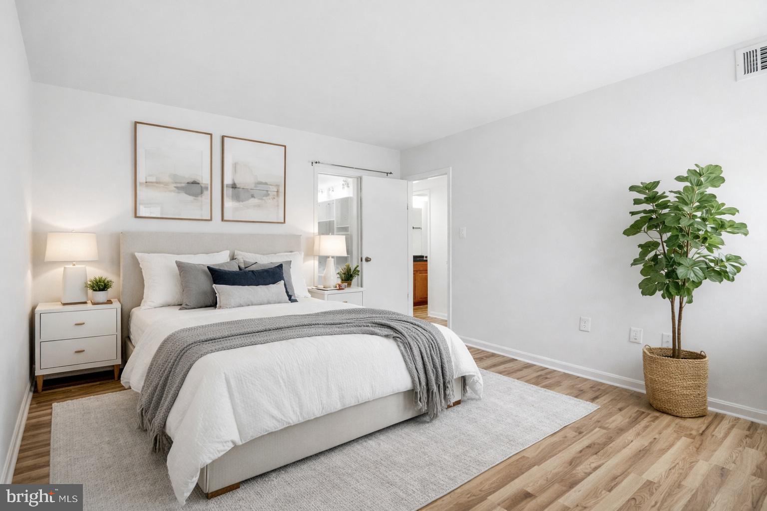 1433 Northgate Square, Unit 11B Reston, VA 20190 - Photo 16 of 44 a bedroom with bed and a potted plant