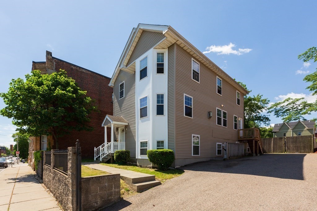 33 Forest Street Boston, MA 02119 - Photo 23 of 23 a front view of a house with a yard
